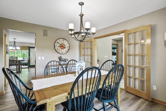 22774 Olivine St NW, Nowthen, MN 55330 - dining room with a chandelier, wood finished floors, and baseboards