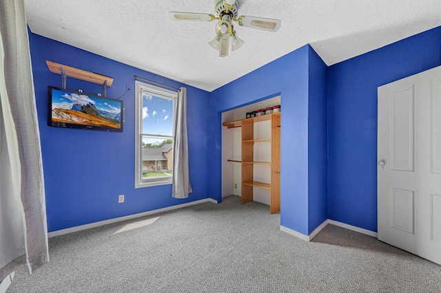 300 Ellington St, West Concord, MN 55985 - unfurnished bedroom featuring carpet floors, a textured ceiling, ceiling fan, and baseboards