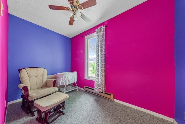 300 Ellington St, West Concord, MN 55985 - living area with a baseboard radiator, a textured ceiling, a ceiling fan, baseboards, and carpet flooring