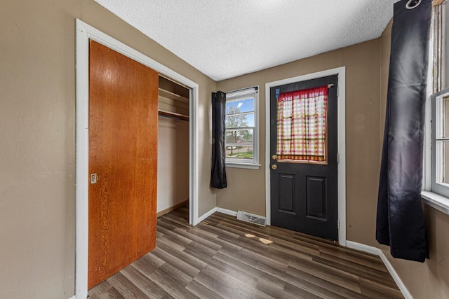 300 Ellington St, West Concord, MN 55985 - foyer entrance featuring wood finished floors, a textured ceiling, and baseboards