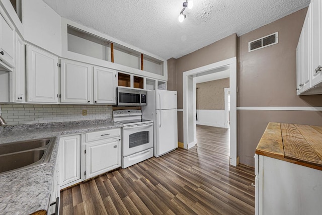 300 Ellington St, West Concord, MN 55985 - kitchen with white appliances, open shelves, a sink, decorative backsplash, and white cabinetry