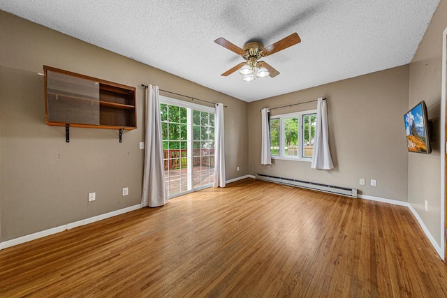 300 Ellington St, West Concord, MN 55985 - unfurnished room featuring a baseboard radiator, wood finished floors, ceiling fan, a textured ceiling, and baseboards