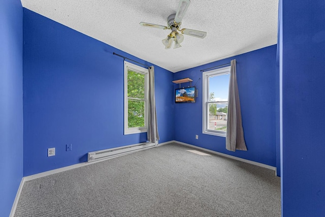 300 Ellington St, West Concord, MN 55985 - carpeted empty room with a baseboard heating unit, a textured ceiling, ceiling fan, and baseboards