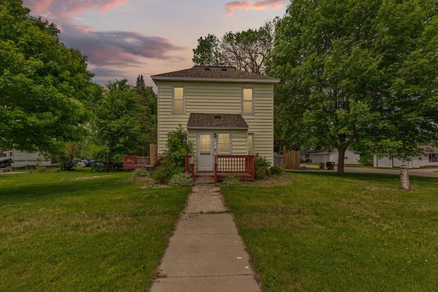300 Ellington St, West Concord, MN 55985 - traditional-style home featuring a front lawn, a deck, and a shingled roof