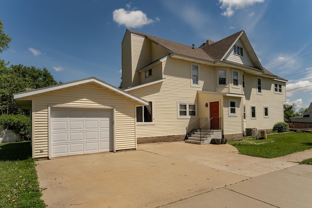 520 State St, West Concord, MN 55985 - view of front of home featuring driveway, a garage, and central air condition unit