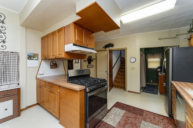 520 State St, West Concord, MN 55985 - kitchen with appliances with stainless steel finishes, under cabinet range hood, crown molding, light floors, and light countertops