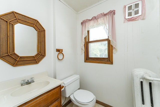 520 State St, West Concord, MN 55985 - bathroom featuring radiator, toilet, vanity, and crown molding