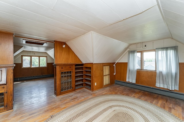 520 State St, West Concord, MN 55985 - bonus room featuring baseboard heating, vaulted ceiling, wood walls, and wood finished floors