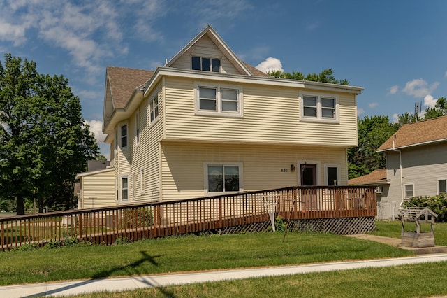 520 State St, West Concord, MN 55985 - back of property featuring a deck, a yard, and a shingled roof
