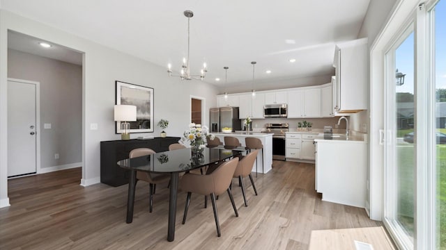 7472 170th Ave NW, Ramsey, MN 55303 - dining space featuring light wood-style flooring, recessed lighting, a chandelier, and baseboards