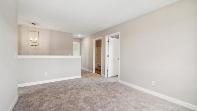 7472 170th Ave NW, Ramsey, MN 55303 - carpeted spare room with a chandelier and baseboards