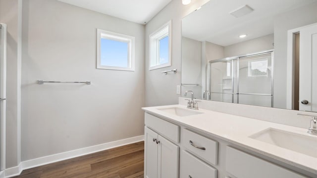 7472 170th Ave NW, Ramsey, MN 55303 - full bath featuring a stall shower, double vanity, baseboards, and wood finished floors