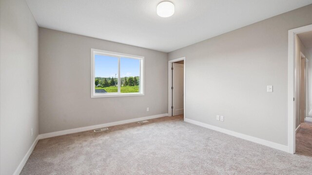 7472 170th Ave NW, Ramsey, MN 55303 - unfurnished bedroom featuring carpet flooring and baseboards