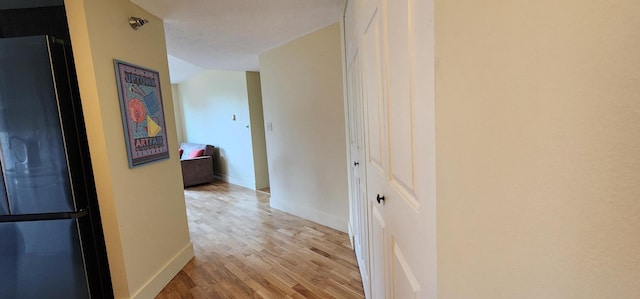 6615 Lake Shore Dr S Unit 717, Richfield, MN 55423 - hallway featuring light wood finished floors and vaulted ceiling