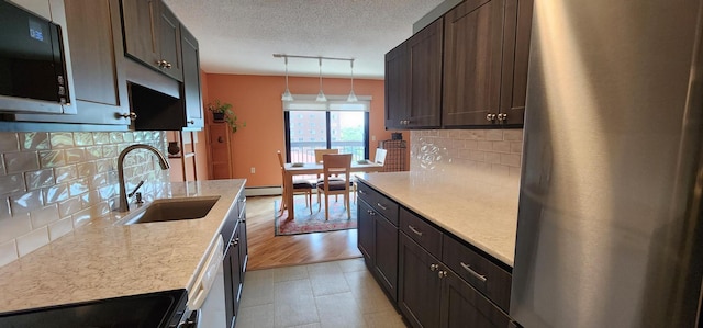6615 Lake Shore Dr S Unit 717, Richfield, MN 55423 - kitchen featuring black microwave, freestanding refrigerator, range, tasteful backsplash, and a textured ceiling
