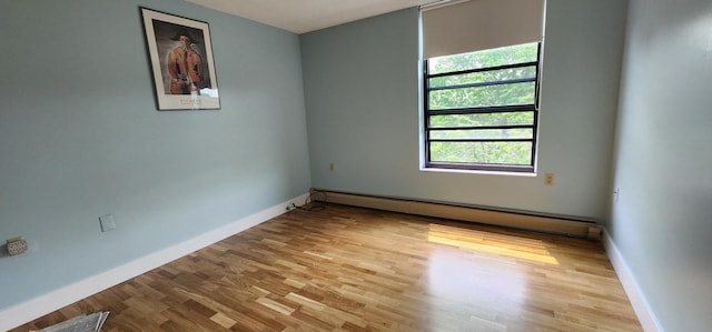 6615 Lake Shore Dr S Unit 717, Richfield, MN 55423 - empty room with a baseboard radiator and wood finished floors