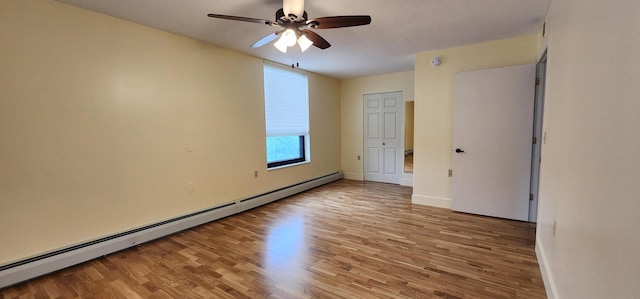 6615 Lake Shore Dr S Unit 717, Richfield, MN 55423 - unfurnished room with a baseboard radiator, wood finished floors, and a ceiling fan