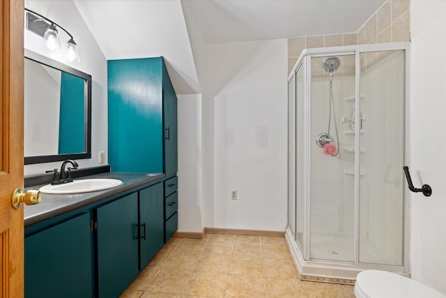 604 16th Ave, Grand Rapids, MN 55744 - full bath featuring a stall shower, vanity, toilet, tile patterned floors, and baseboards