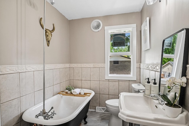404 8th Ave S, Princeton, MN 55371 - full bath with a freestanding bath, tile walls, toilet, and wainscoting