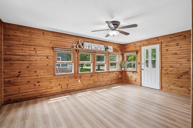 404 8th Ave S, Princeton, MN 55371 - unfurnished room with wood walls, light wood finished floors, and ceiling fan