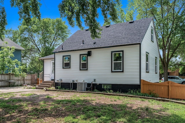 404 8th Ave S, Princeton, MN 55371 - rear view of house with a shingled roof and central air condition unit
