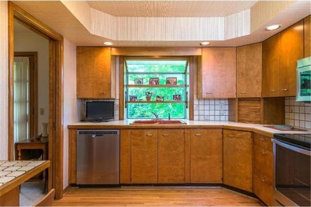 5157 Abercrombie Dr, Edina, MN 55439 - kitchen featuring stainless steel appliances, a sink, backsplash, brown cabinetry, and recessed lighting