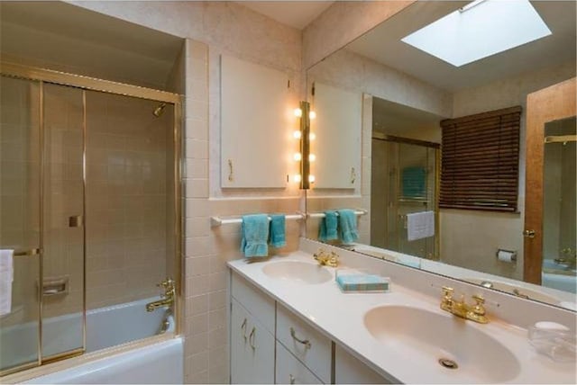 5157 Abercrombie Dr, Edina, MN 55439 - bathroom featuring a skylight, bath / shower combo with glass door, and double vanity