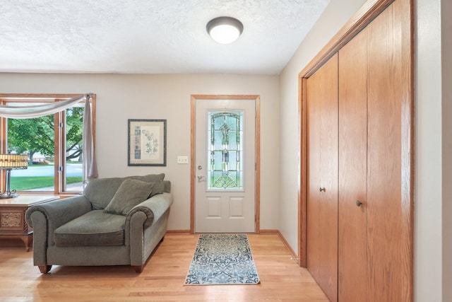 1852 13th Ave W, Shakopee, MN 55379 - foyer featuring light wood-style flooring and a textured ceiling