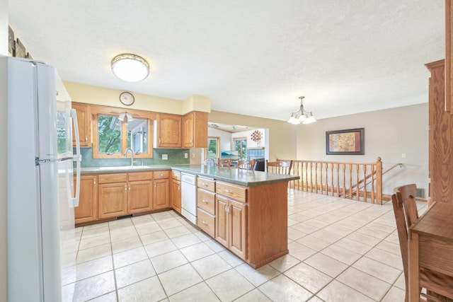 1852 13th Ave W, Shakopee, MN 55379 - kitchen with white appliances, a peninsula, healthy amount of natural light, and a sink