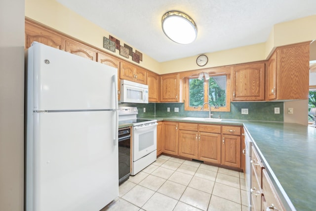 1852 13th Ave W, Shakopee, MN 55379 - kitchen with white appliances, a sink, backsplash, light tile patterned floors, and brown cabinets