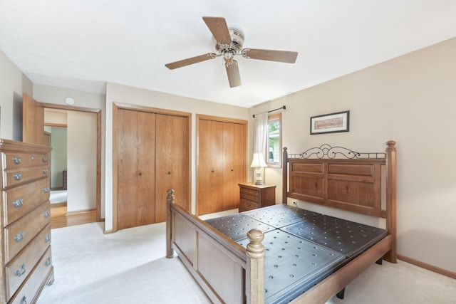 1852 13th Ave W, Shakopee, MN 55379 - bedroom featuring two closets, light carpet, a ceiling fan, and baseboards