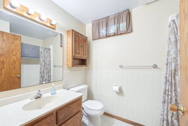 1852 13th Ave W, Shakopee, MN 55379 - full bath with tile walls, vanity, toilet, tile patterned floors, and a wainscoted wall