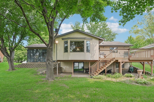 1852 13th Ave W, Shakopee, MN 55379 - rear view of property featuring stairs, a wooden deck, stucco siding, a lawn, and a sunroom