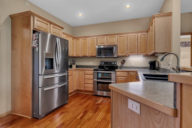 25845 12th St W, Zimmerman, MN 55398 - kitchen featuring appliances with stainless steel finishes, light brown cabinets, a sink, light wood-style floors, and recessed lighting
