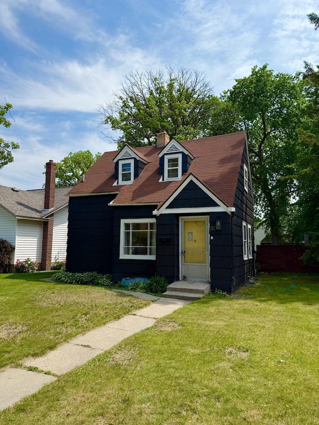 310 Saint Paul Ave S, Thief River Falls, MN 56701 - view of front of property with a front lawn and a chimney