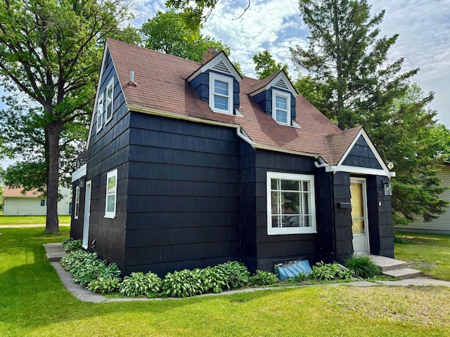 310 Saint Paul Ave S, Thief River Falls, MN 56701 - view of front of home with a chimney, a front lawn, and roof with shingles