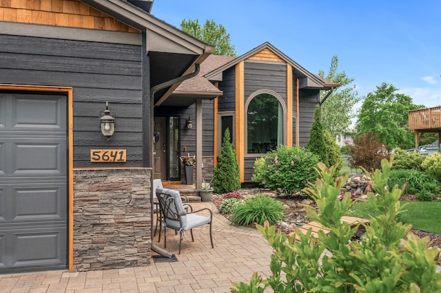 5641 146th Ave NW, Ramsey, MN 55303 - property entrance featuring a garage and stone siding