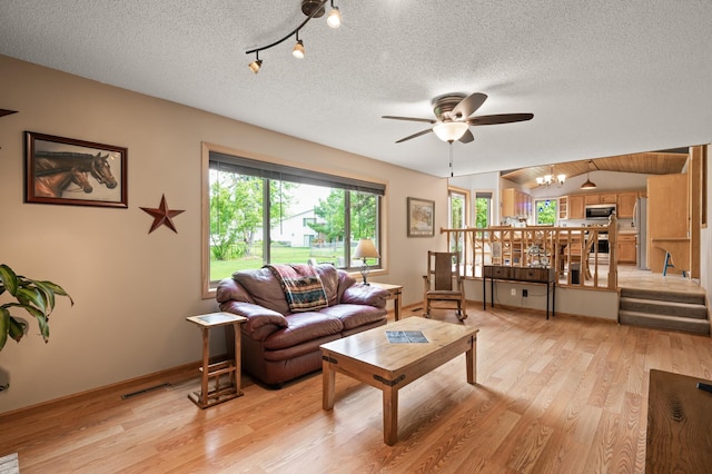 5641 146th Ave NW, Ramsey, MN 55303 - living room with a ceiling fan, light wood finished floors, a textured ceiling, and baseboards