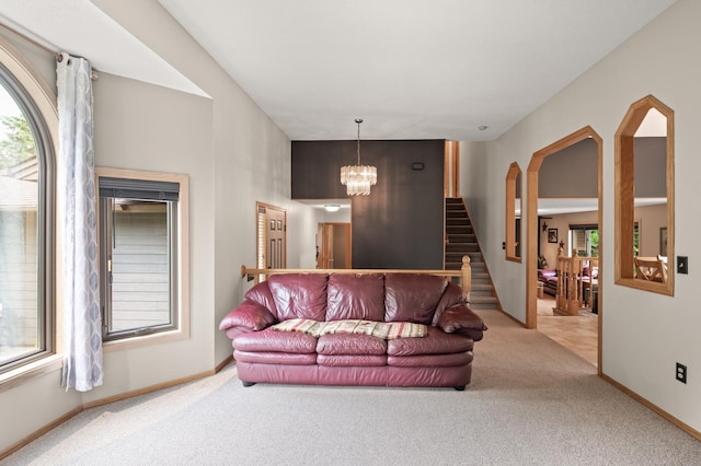5641 146th Ave NW, Ramsey, MN 55303 - carpeted living area featuring stairway, baseboards, a chandelier, and arched walkways