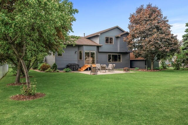 5641 146th Ave NW, Ramsey, MN 55303 - rear view of property with a patio, a lawn, and a shingled roof