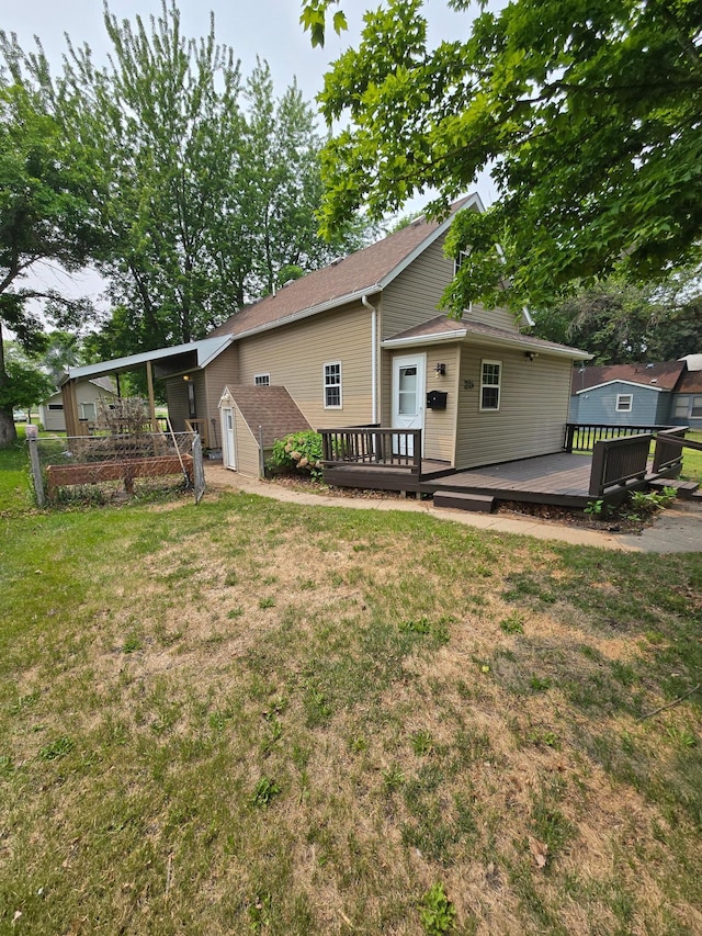 25 Morgan St, Tracy, MN 56175 - rear view of property featuring a wooden deck and a lawn