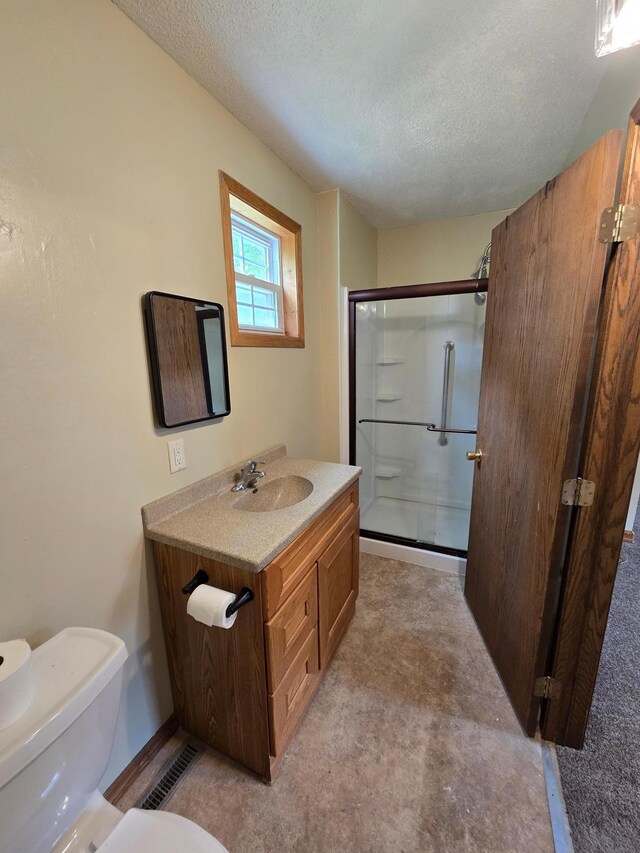 25 Morgan St, Tracy, MN 56175 - full bathroom with a stall shower, a textured ceiling, vanity, toilet, and baseboards
