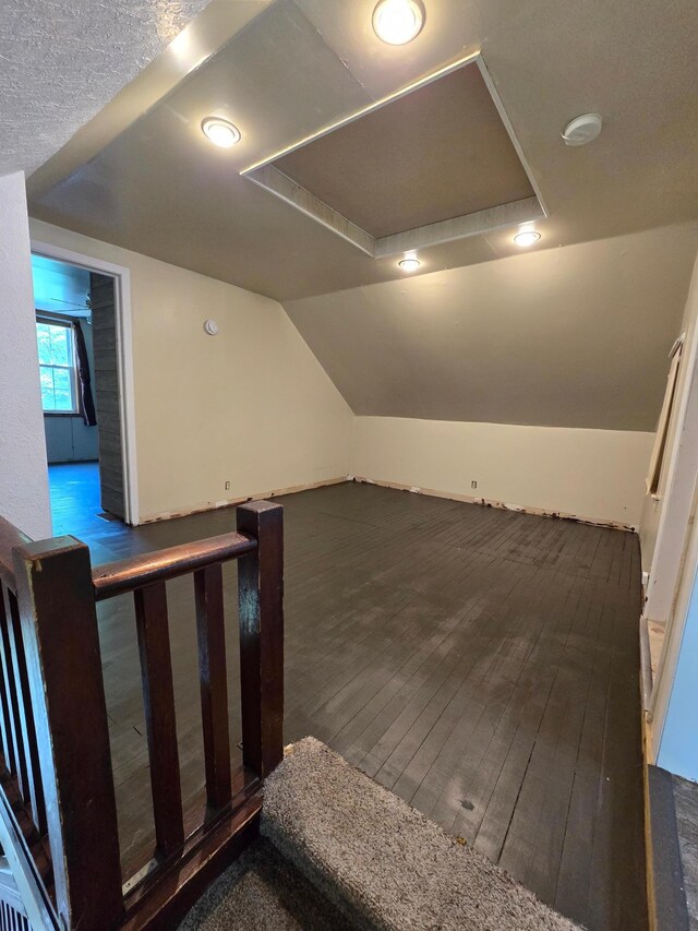 25 Morgan St, Tracy, MN 56175 - additional living space with hardwood / wood-style flooring, vaulted ceiling, and attic access