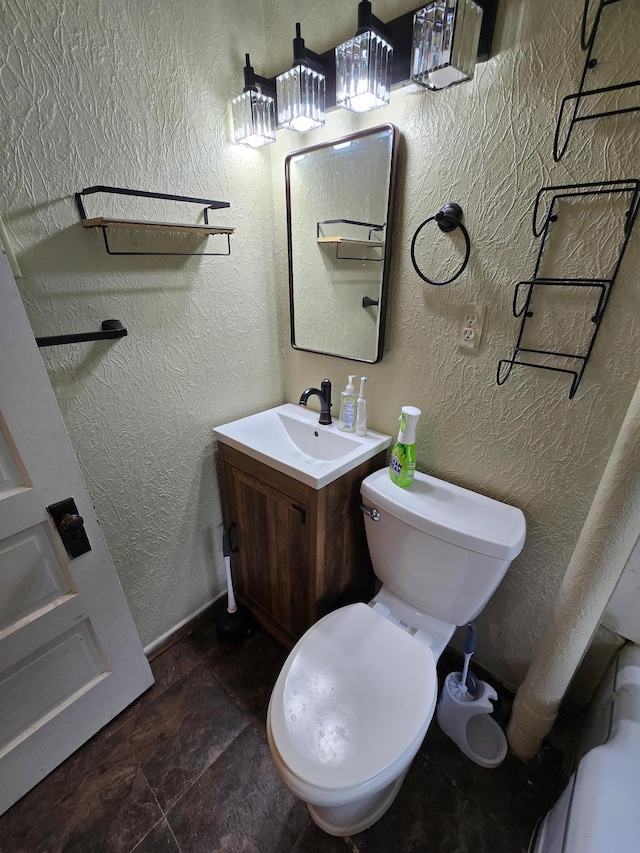 25 Morgan St, Tracy, MN 56175 - bathroom with toilet, vanity, stone finish floors, and a textured wall