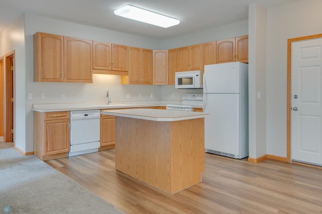 3401 28th St SW # 108, Fargo, ND 58104 - kitchen with white appliances, a sink, light brown cabinetry, and light countertops