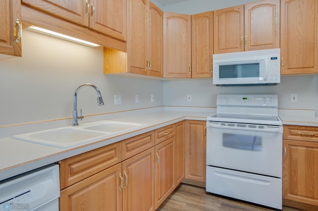 3401 28th St SW # 108, Fargo, ND 58104 - kitchen featuring white appliances, a sink, light brown cabinets, light countertops, and light wood-style flooring