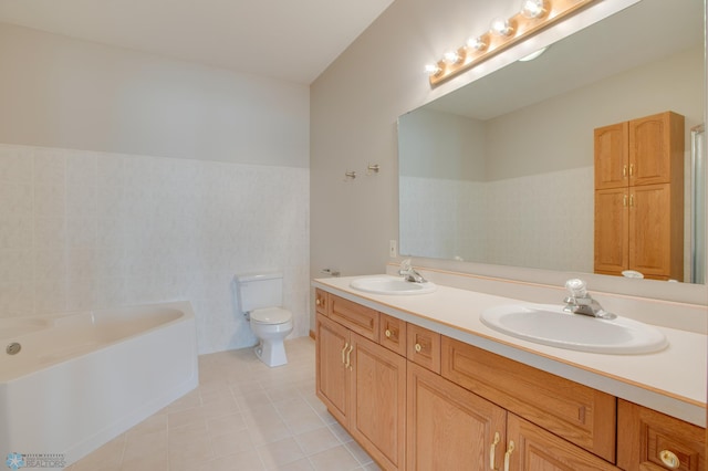 3401 28th St SW # 108, Fargo, ND 58104 - bathroom featuring a garden tub, double vanity, toilet, tile patterned floors, and tile walls