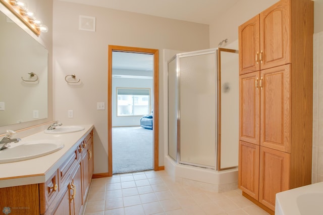 3401 28th St SW # 108, Fargo, ND 58104 - bathroom featuring a shower stall, double vanity, and tile patterned flooring