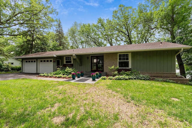 13100 Island View Dr NW, Elk River, MN 55330 - single story home featuring a garage, asphalt driveway, board and batten siding, and a front yard