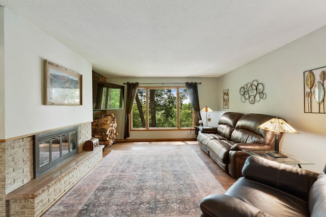13100 Island View Dr NW, Elk River, MN 55330 - living room with a fireplace, a textured ceiling, and wood finished floors